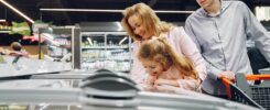 Busy supermarket aisle showing current grocery prices in New Zealand 2026