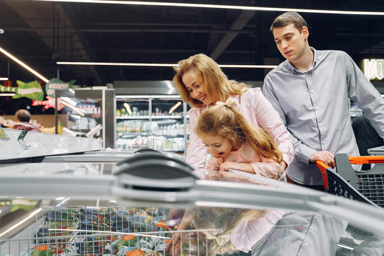 Busy supermarket aisle showing current grocery prices in New Zealand 2026