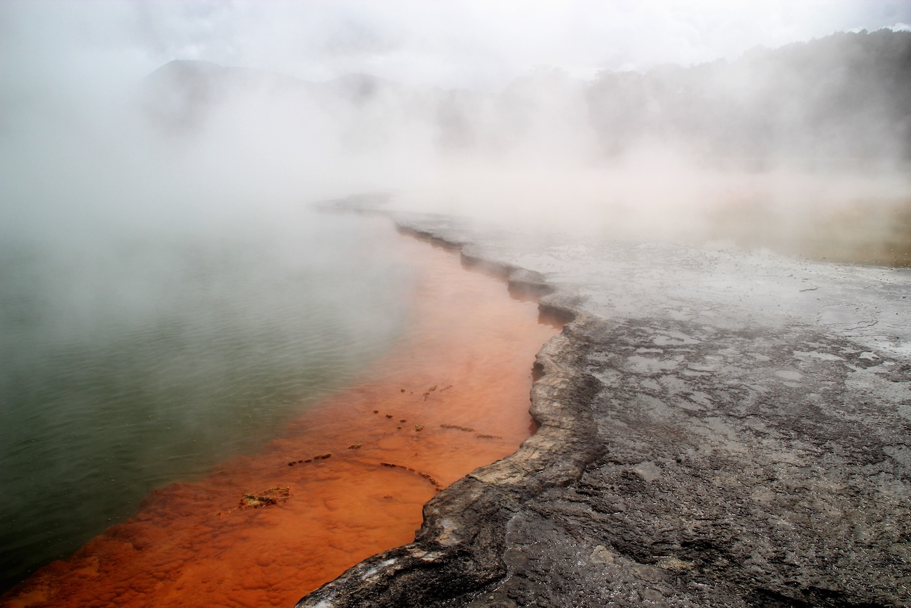 Vibrant orange edges of the Champagne Pool at Wai-O-Tapu Thermal Wonderland, a highlight among places to visit in Rotorua